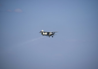 The spraying of fertilizers and pesticides on the field with the aircraft.