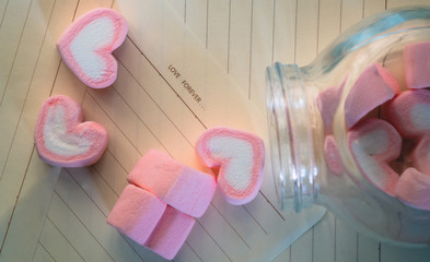 pink marshmallows and word LOVE FOREVER on brown paper