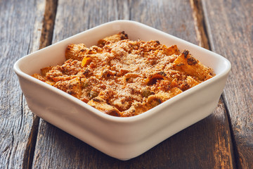 Close-up baked pasta with mince, ragù sauce.