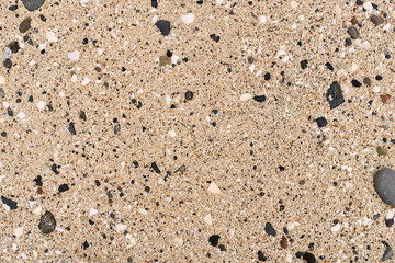 Abstract, texture view of a coral beach with pebbles on it.