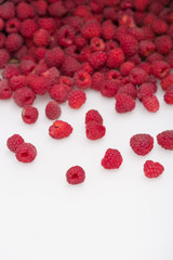 fresh organic raspberries. Summer berries dessert and snacks cattered on white background. Healthy food and summer concept