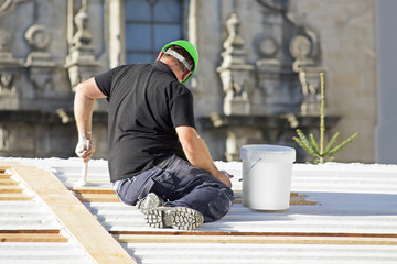painter man working  to repairing and painting the wooden house © GDM photo and video