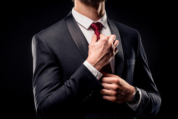 Businessman adjusting tie