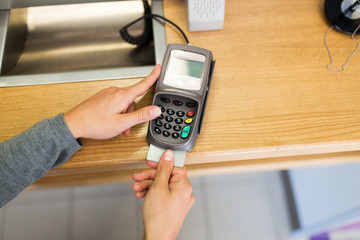 close up of hand inserting bank card to terminal