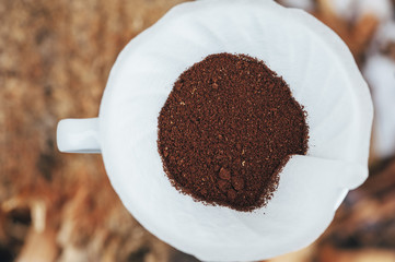 Delicious freshly ground morning coffee powder in the coffee filter