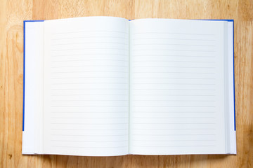 Blank paper note book on wood table background