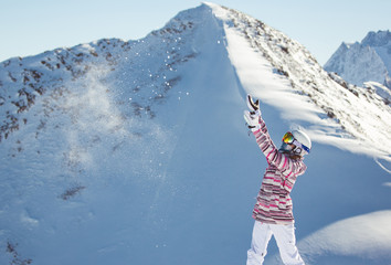 Female snowboarder in the alpine mountains