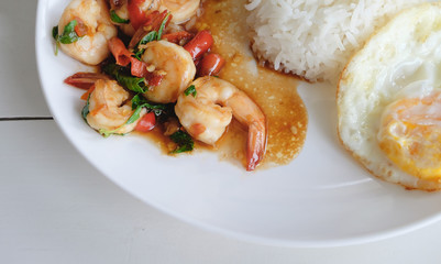 Closed up fried rice with basil shrimp and fired egg. Popular thai food.