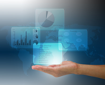 Man's hand showing digital financial diagram on blurred map background