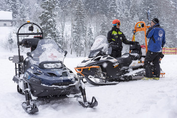 Mountain Assistance Rescue Patrol with Snowmobiles in Ski Winter Season