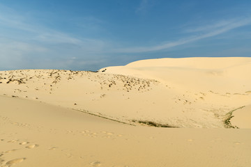 Fototapeta na wymiar White sand dunes with blue skies, Mui Ne, Vietnam