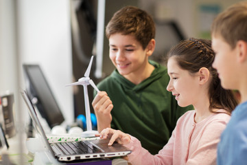children with laptop and wind turbine at school