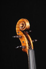 Detail of old wooden violin on black background