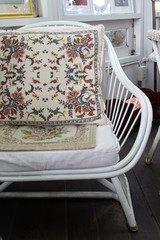 Fototapeta na wymiar White wicker chair and cushion pink.