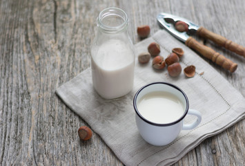 Obraz na płótnie Canvas Glass of hazelnut milk on wooden background