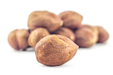 A bunch of hazelnuts on a white background. Raw hazelnuts isolated on white background