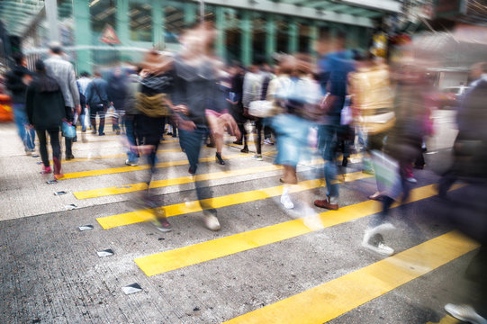 Conceptual motion blur picture of people crossing the street in a big city