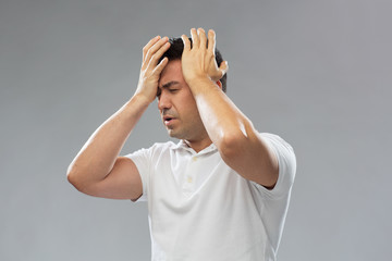 unhappy man suffering from head ache