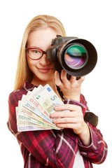 Successful woman with money and camera