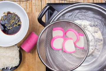 Chef boiling kamaboko (fish cake) in pot