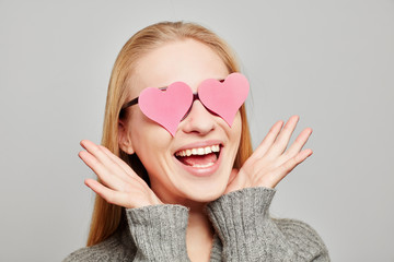 Woman in love with two pink hearts on her eyes