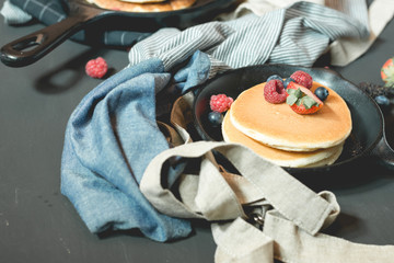 pancake with fresh fruit and berry stack on pan