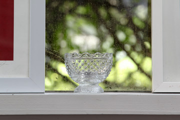 The retro water glass on the window sill.