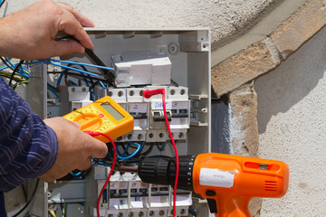electrician at work with an electric panel