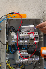 electrician at work with an electric panel