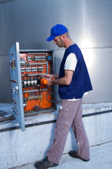 electrician at work with an electric panel