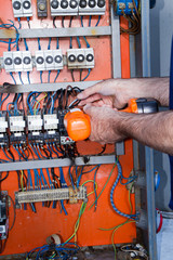 electrician at work with an electric panel