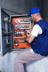 electrician at work with an electric panel
