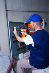 electrician at work with an electric panel