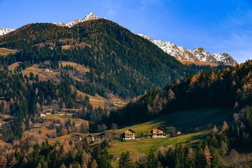 idyllic landscape in alps with mountain chalet