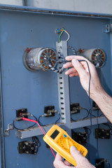 electrician at work with an electric panel