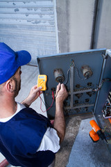 electrician at work with an electric panel