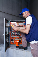 electrician at work with an electric panel