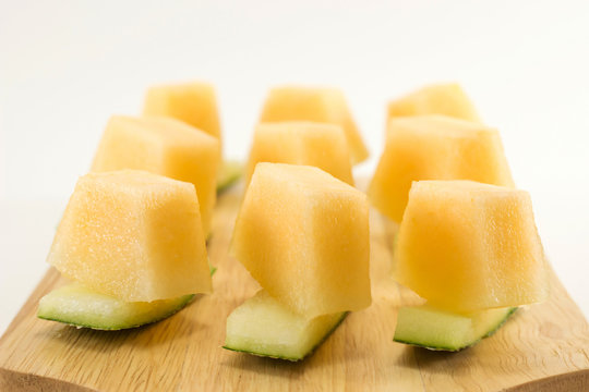 Fresh melons served on wooden plate