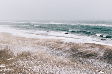 Abstract winter landscape of beach during a snowfall and wind