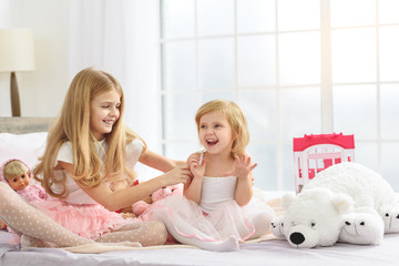 Little sisters enjoying time together at home