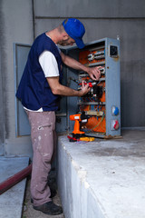 electrician at work with an electric panel