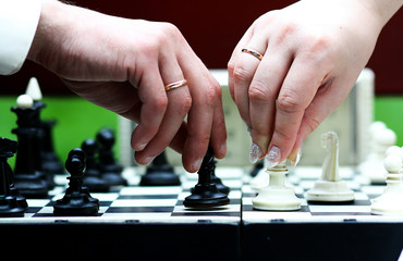 Let's play the game. Hands of married people play chess