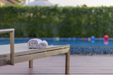 Towels on the recliner bed by the resort pool