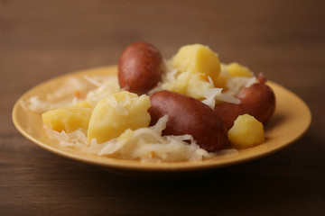 Sauerkraut and smoked sausage. Dish with sauerkraut, sausage and potatoes.