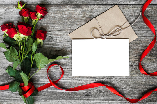 blank white greeting card and envelope with red roses flowers