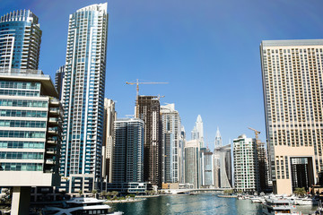 Fototapeta na wymiar Tall skyscrapers built on both sides of the river in Dubai