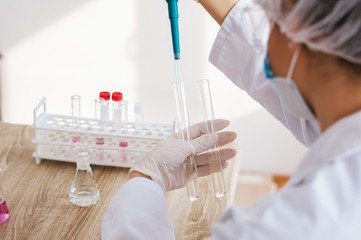 Young female scientist making experiments in laboratory