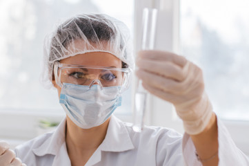 Young female scientist making experiments in laboratory