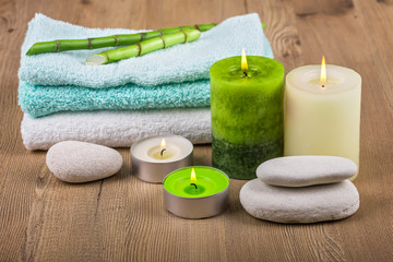 Fototapeta na wymiar Spa concept / Spa decoration with candles, towels and spa stones
