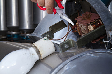 electrician repairing street lamps in a industrial site